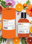 CRUSH ZING Apa de parfum exotic fructat floral 100ml, sticlă portocalie cu ambalaj cilindric, portocale și orhidee tropicale în fundal