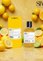 Apa de parfum CRUSH ZEST citric și floral, sticlă și ambalaj galben lângă lămâi și lime, parfum de vară intens