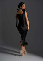 Rochie SIA Black Widow, Rochie midi neagră mulată din tafta cu aplicații din pene, vedere din spate pe model elegant